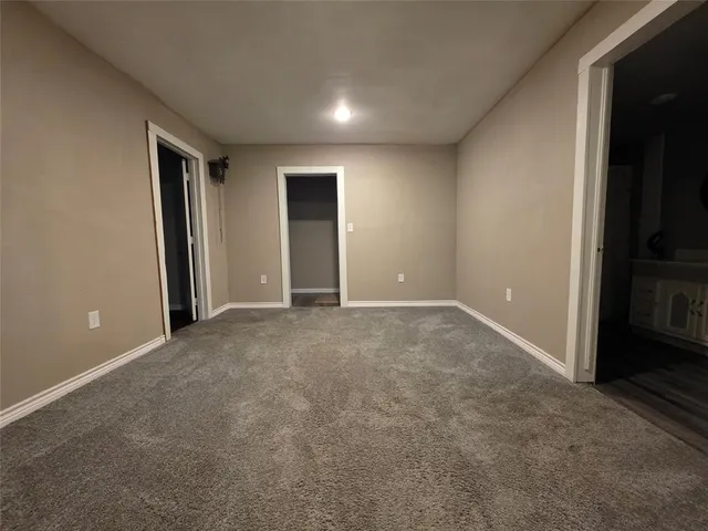 an empty room with window and wooden floor