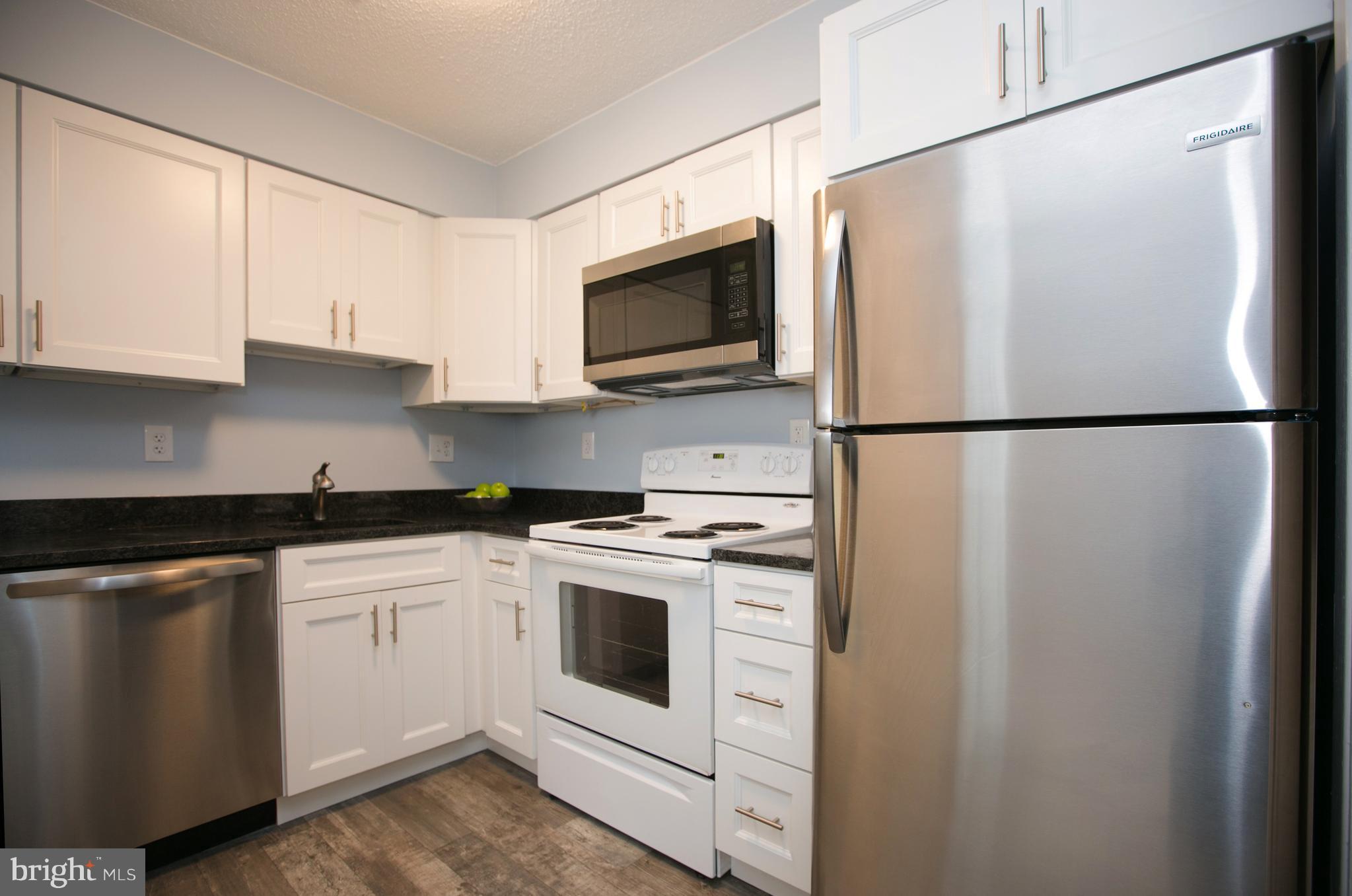 2330 Southgate Square Reston, VA 20191 - Photo 11 of 28 a white refrigerator freezer sitting in a kitchen