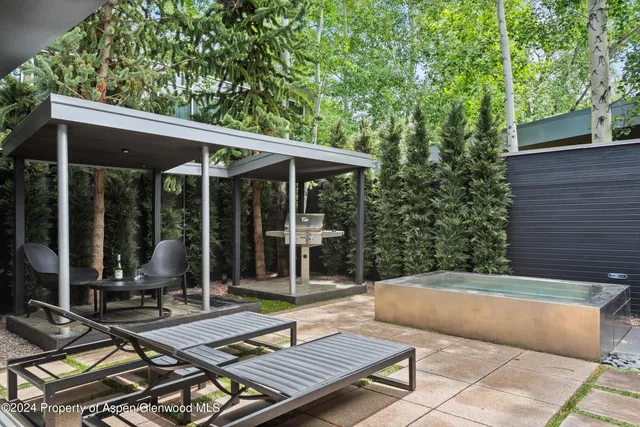 a view of a two chairs in the patio