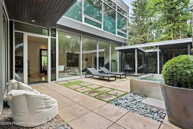 a view of a house with backyard porch and sitting area