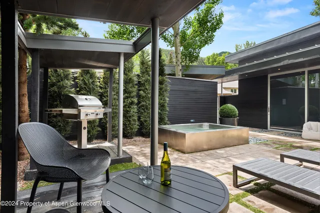 a view of a patio with table and chairs and potted plants