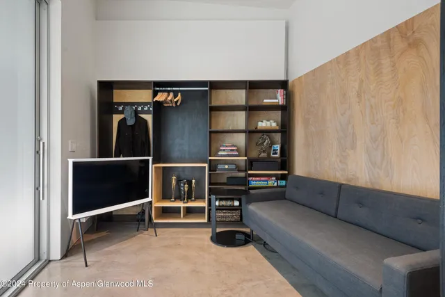 a living room with furniture a ceiling fan and a window
