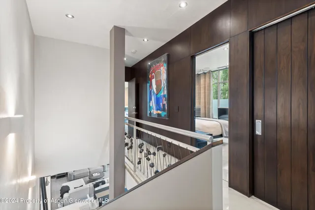 a view of a hallway with wooden floor and front door