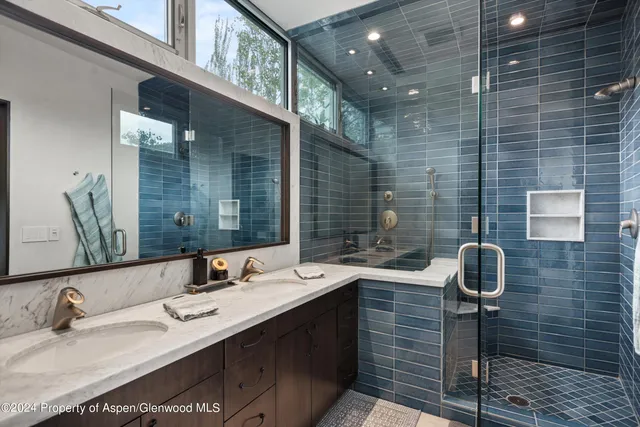 a bathroom with a double vanity sink and a mirror