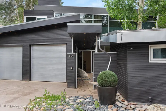 a front view of a house with potted plants