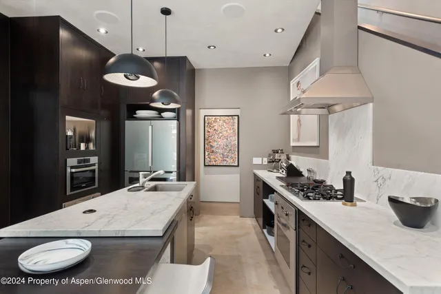 a kitchen with a table and chairs in it