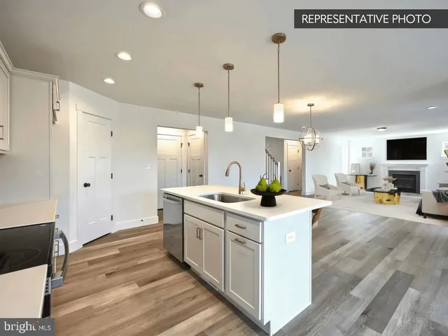 a kitchen with a sink stove and white cabinets
