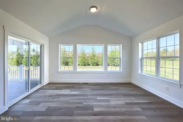 a living room with furniture and large windows