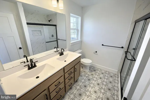 a bathroom with a glass shower door