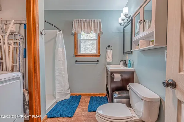 a bathroom with a toilet and a shower curtain