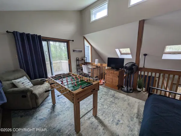 a living room with furniture a rug and a window