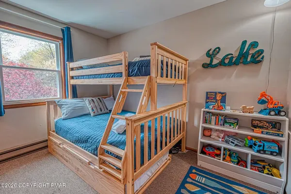 a living room with furniture and a book shelf