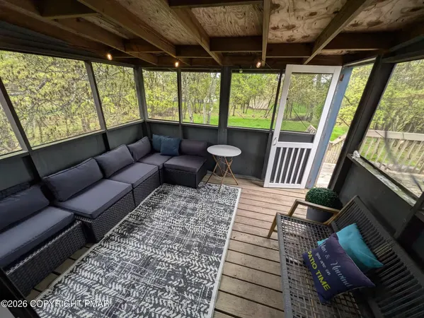 a living room with furniture and a large window