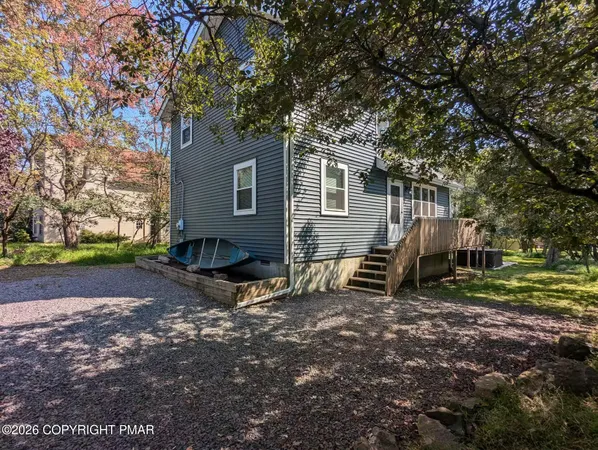 a backyard of a house with barbeque oven table and chairs