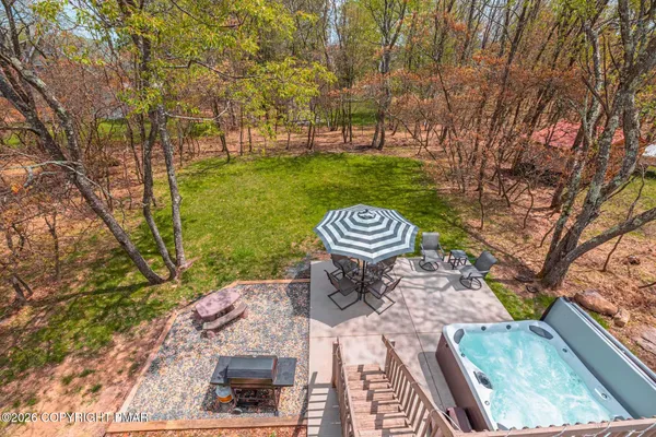 a view of a chairs and table in backyard