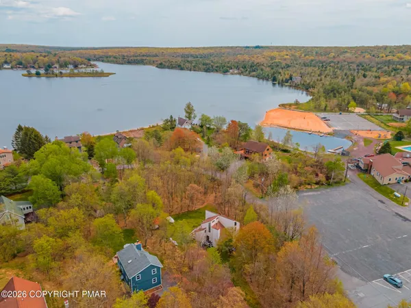 an aerial view of a houses with a lake view