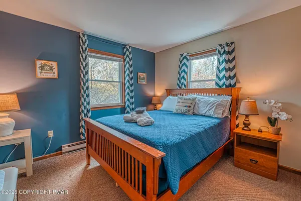 a bed sitting in a bedroom next to a window