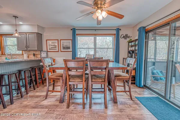 a view of a dining room with furniture window and wooden floor