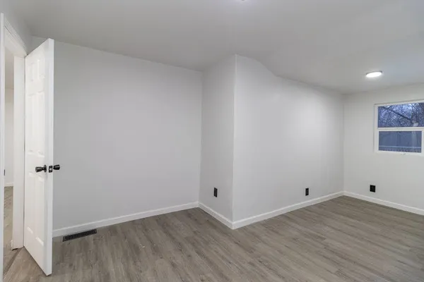 a view of room with wooden floor