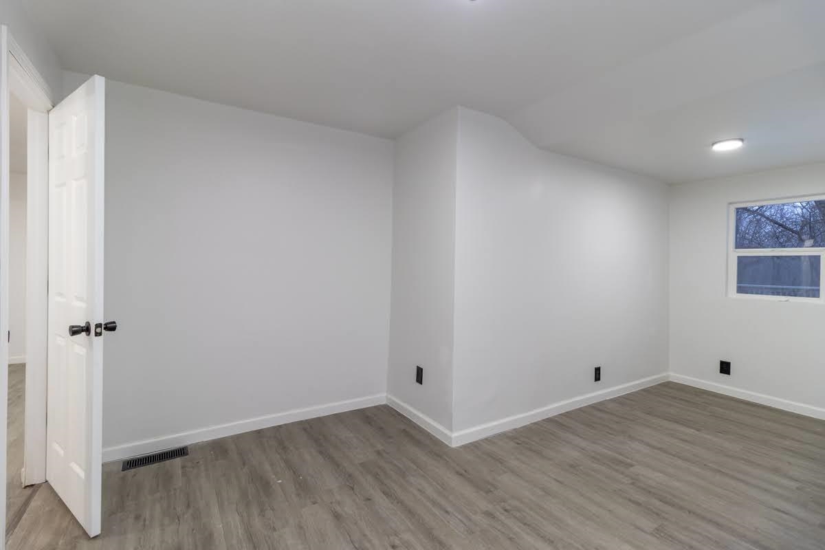 a view of room with wooden floor