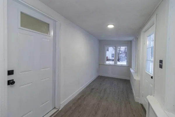 a view of an empty room and a window