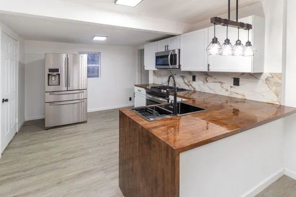 a kitchen with granite countertop a stove and a sink