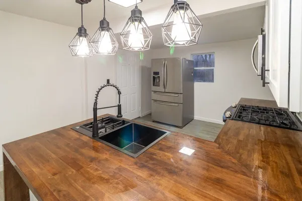 a bedroom with a bed and chandelier