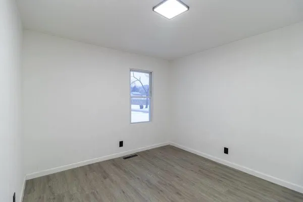 a view of a room that has wooden floor