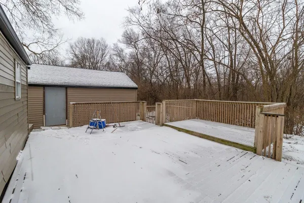 a view of house with backyard and trees in the background