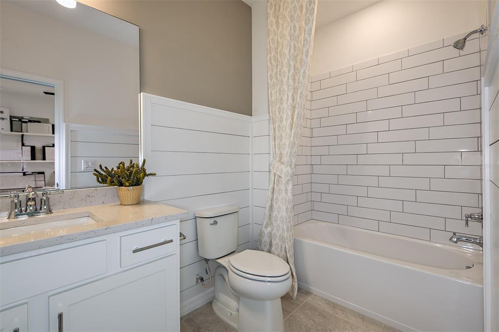 33425 Herds Hallow Way Wesley Chapel, FL 33545 - Photo 15 of 30 a bathroom with a sink a toilet and bathtub