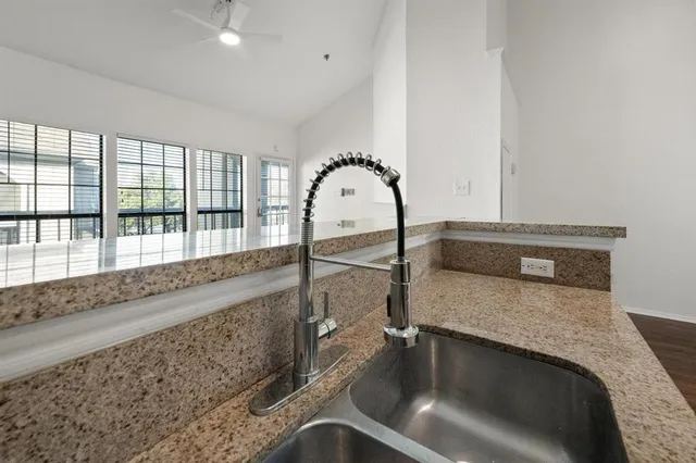 a kitchen with a sink and a large window