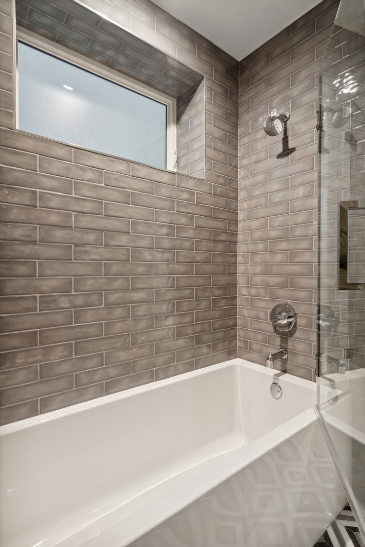 232 South Green Street, Unit 3S Chicago, IL 60607 - Photo 20 of 23 a bathroom with a bathtub and shower