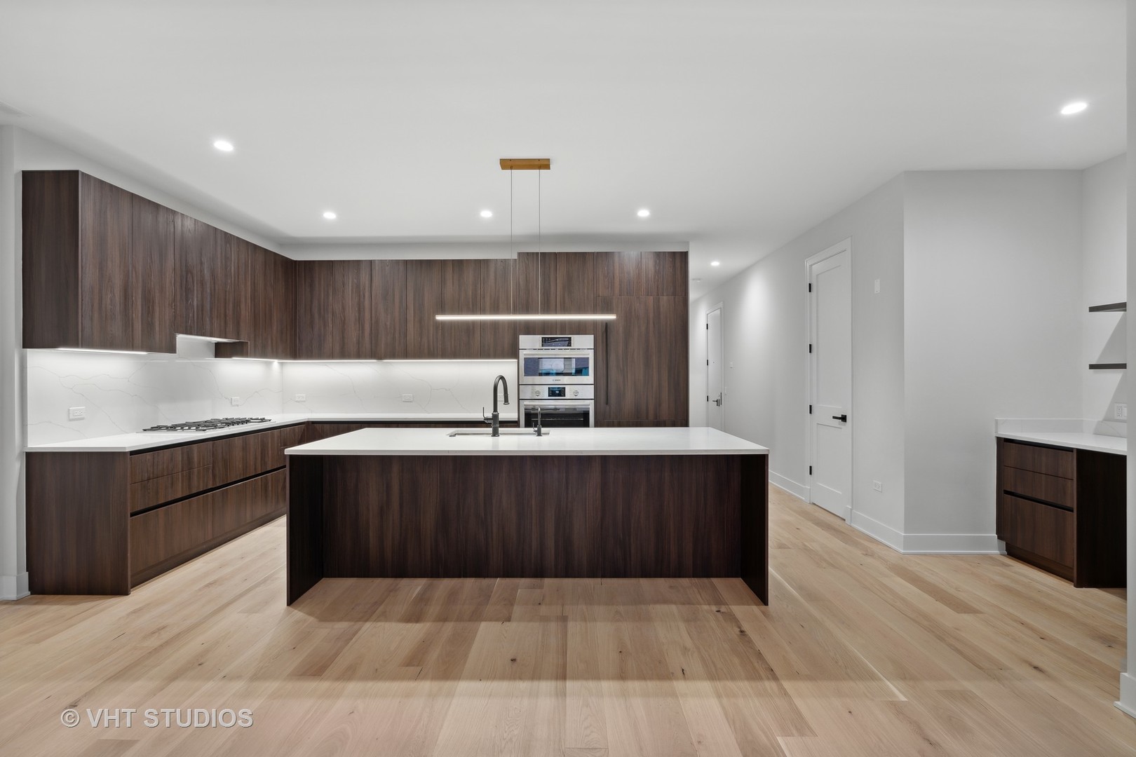 232 South Green Street, Unit 3S Chicago, IL 60607 - Photo 2 of 23 a kitchen with wooden cabinets and center island