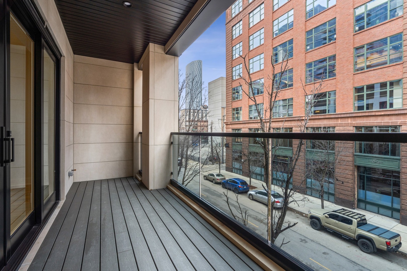 232 South Green Street, Unit 3S Chicago, IL 60607 - Photo 21 of 23 a view of a balcony with wooden floor and iron stairs