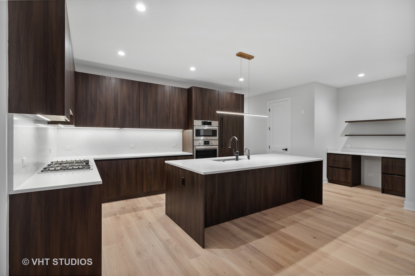 232 South Green Street, Unit 3S Chicago, IL 60607 - Photo 5 of 23 a kitchen with kitchen island granite countertop a sink counter top space and stainless steel appliances