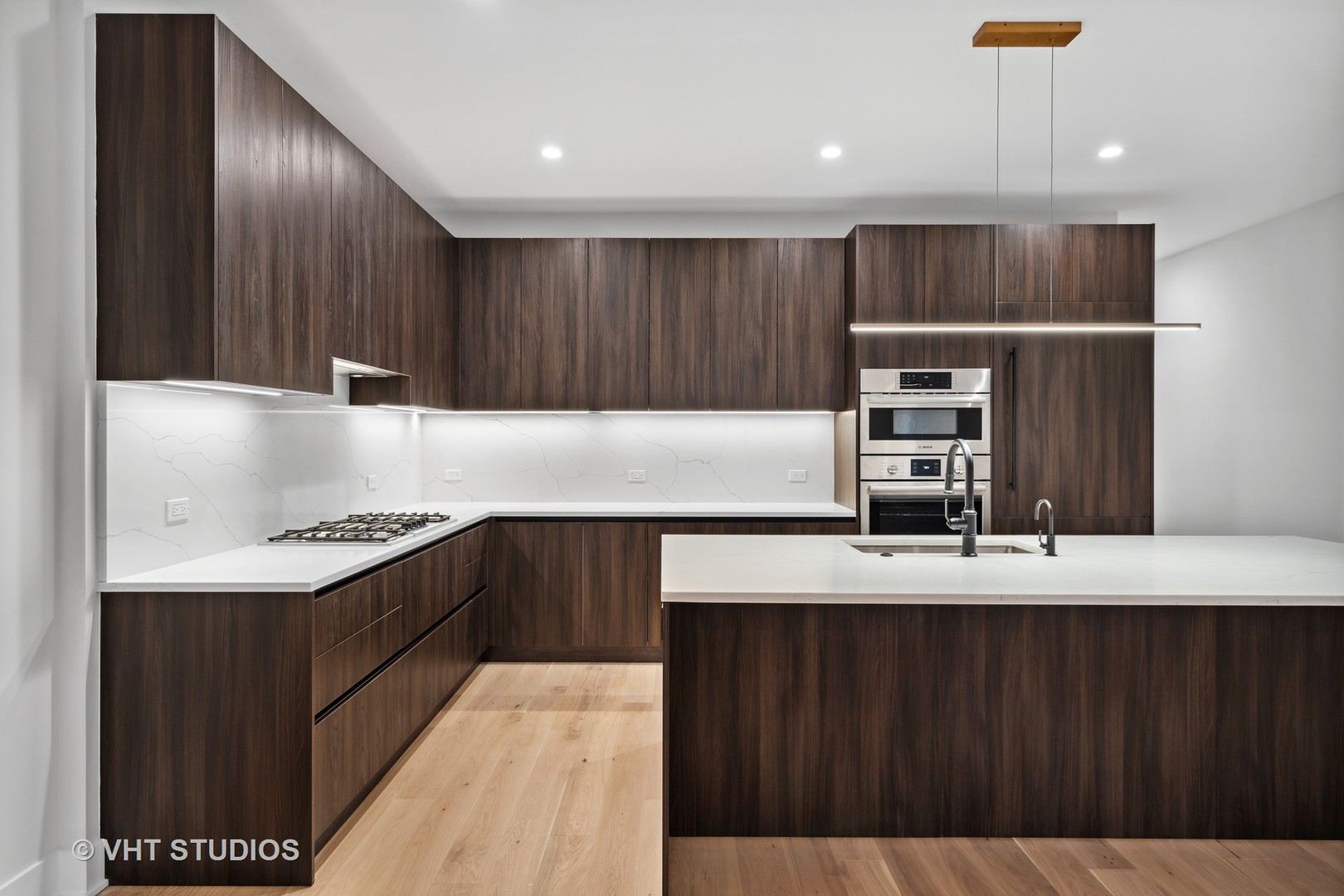 232 South Green Street, Unit 3S Chicago, IL 60607 - Photo 6 of 23 a kitchen with kitchen island granite countertop a sink stainless steel appliances and cabinets