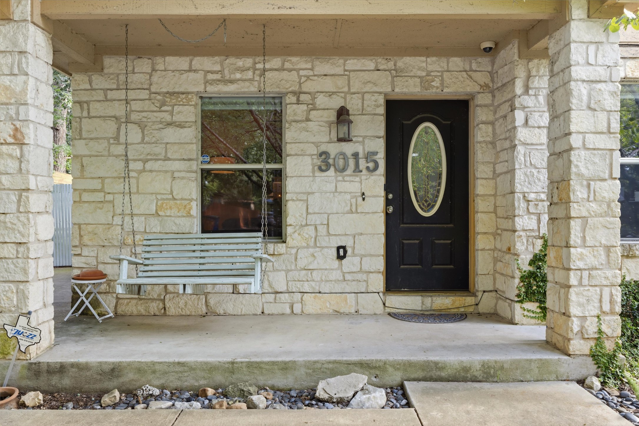 3015 Castro Street Austin, TX 78702 - Photo 5 of 40 A welcoming stone facade with a swing-equipped covered porch invites relaxation.