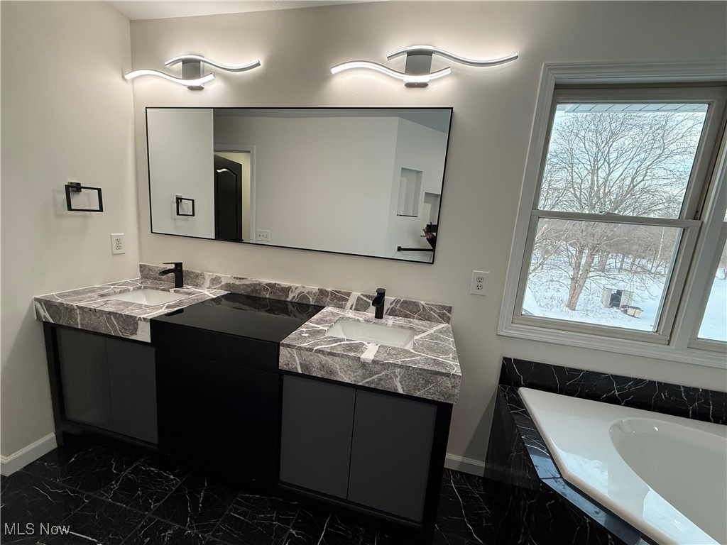 31295 Arthur Road Solon, OH 44139 - Photo 27 of 50 Bathroom with vanity and tiled bath