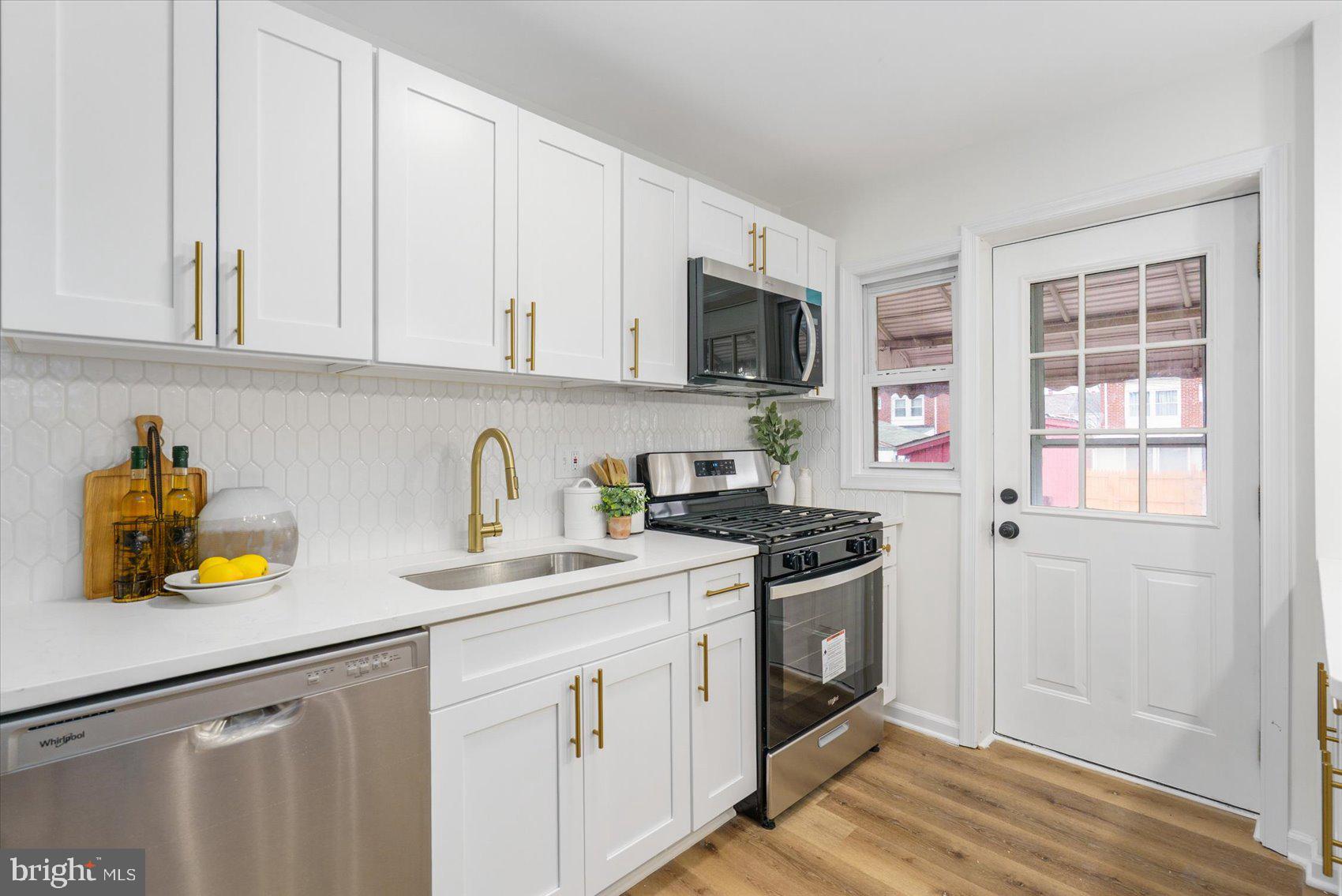 2053 Jasmine Road Baltimore, MD 21222 - Photo 16 of 34 a kitchen with stainless steel appliances granite countertop a sink stove and cabinets
