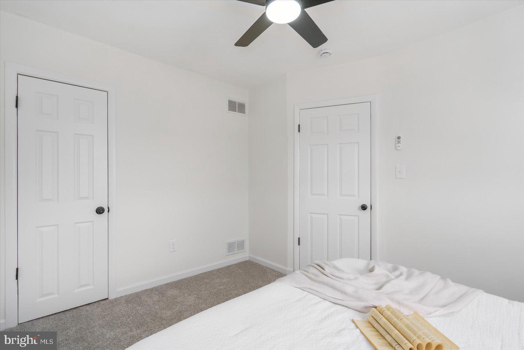 2053 Jasmine Road Baltimore, MD 21222 - Photo 29 of 34 a bedroom with a bed and a ceiling fan
