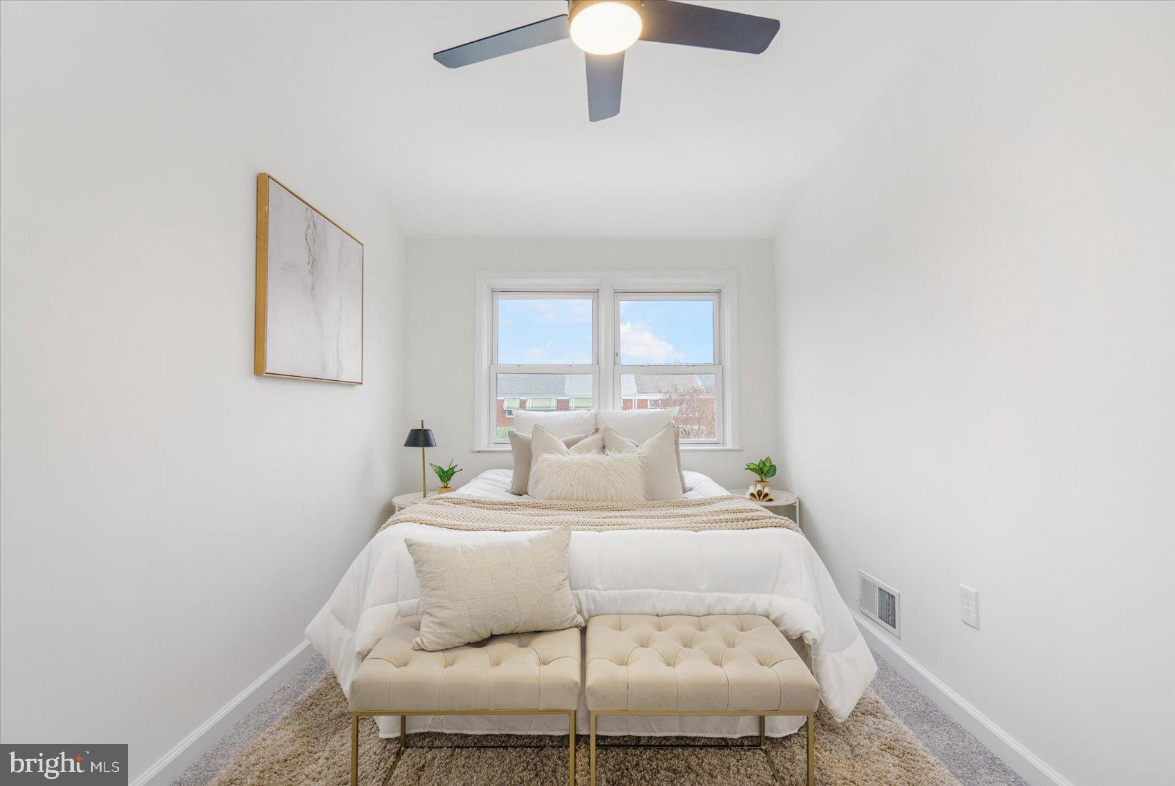 2053 Jasmine Road Baltimore, MD 21222 - Photo 33 of 34 a bedroom with a bed and a chandelier