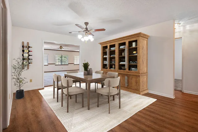 a kitchen with stainless steel appliances granite countertop a sink a stove and a wooden cabinets