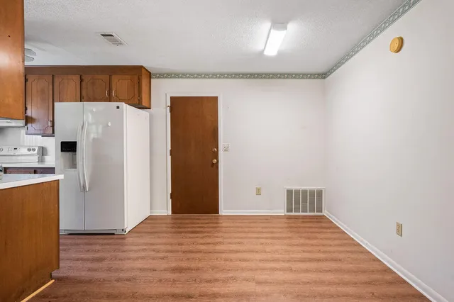 a kitchen with stainless steel appliances granite countertop a sink a stove and a microwave