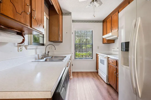 a view of kitchen with granite countertop cabinets and wooden floor