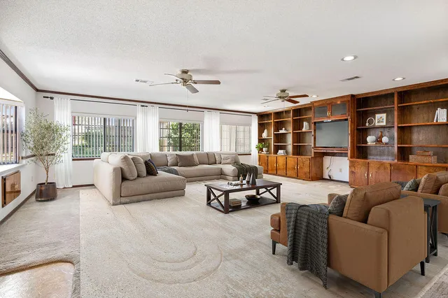 a view of room with window and ceiling fan