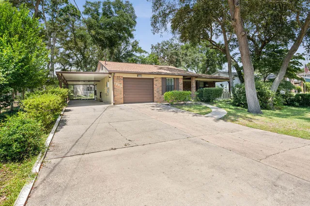 a view of a house with a tree in a yard