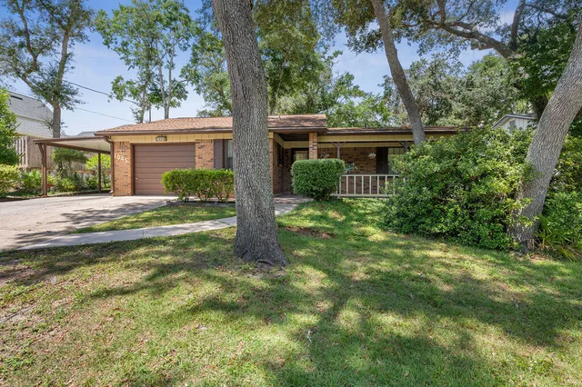 a front view of house with a garden