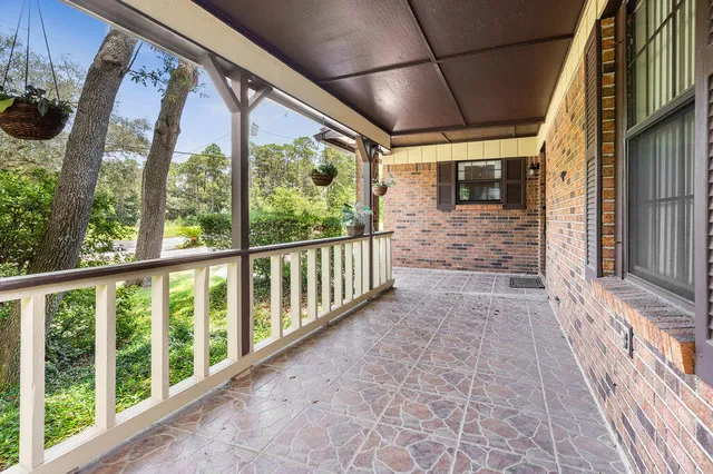 a view of a kitchen with refrigerator and wooden floor