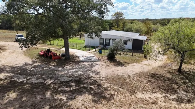 a view of a house with backyard porch and sitting area