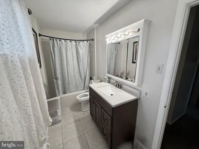 a bathroom with a double vanity sink and mirror